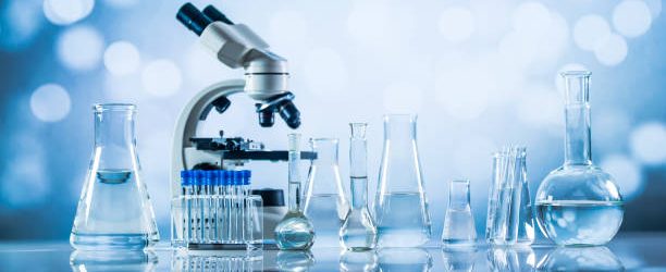 Zdenek Hel Science laboratory research and development concept. microscope with test tubes